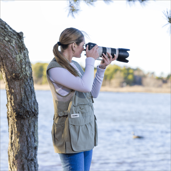 Model using camera and wearing a camera vest Model using camera and wearing a camera vest